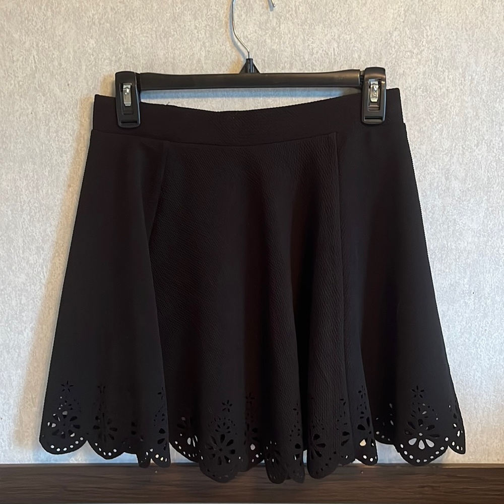 Black mini skirt with a beautiful detailed hem.